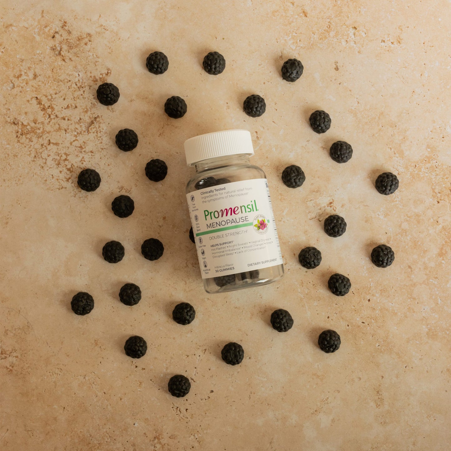 Promensil Menopause Double Strength Gummies bottle and gummies layed on beige background