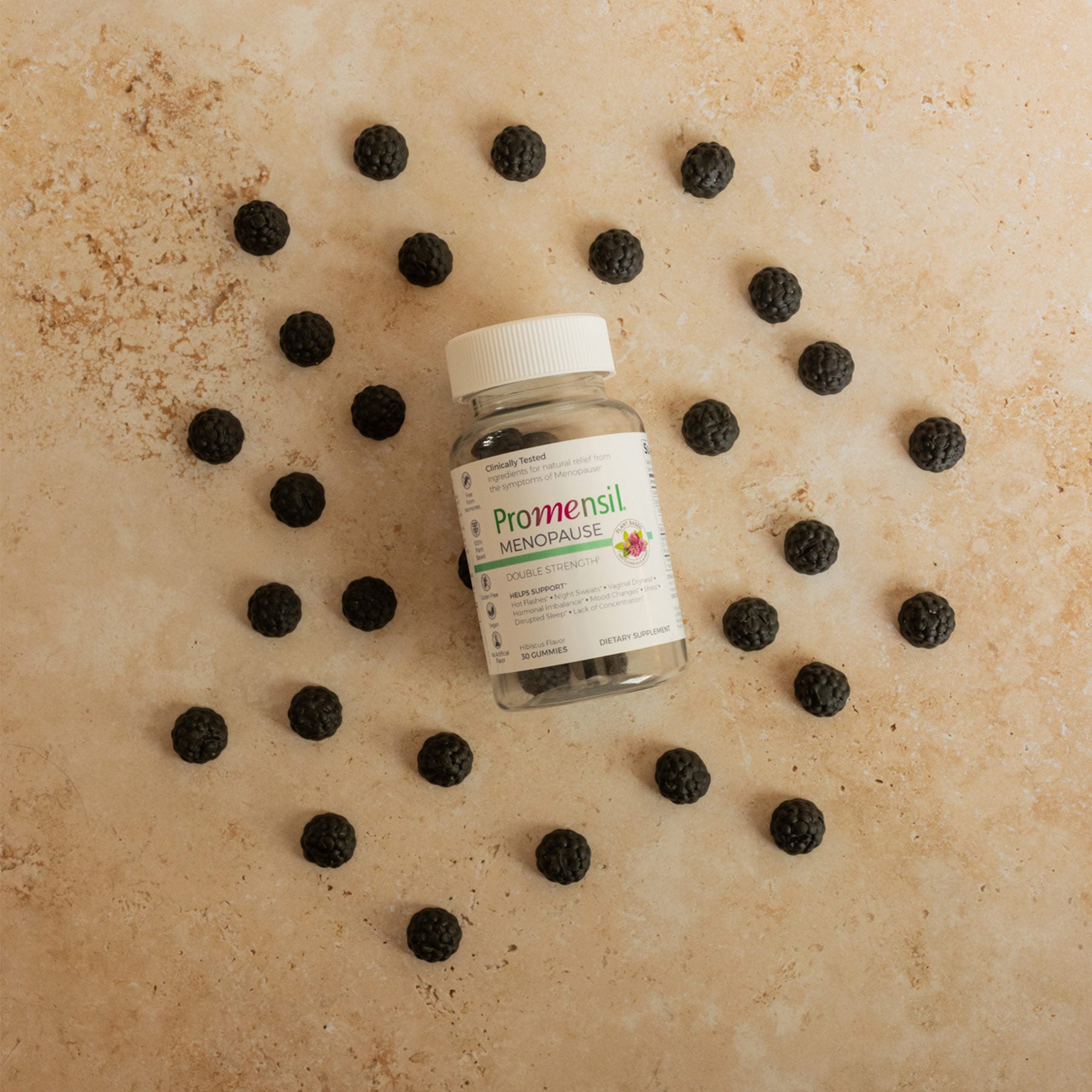 Promensil Menopause Double Strength Gummies bottle and gummies layed on beige background