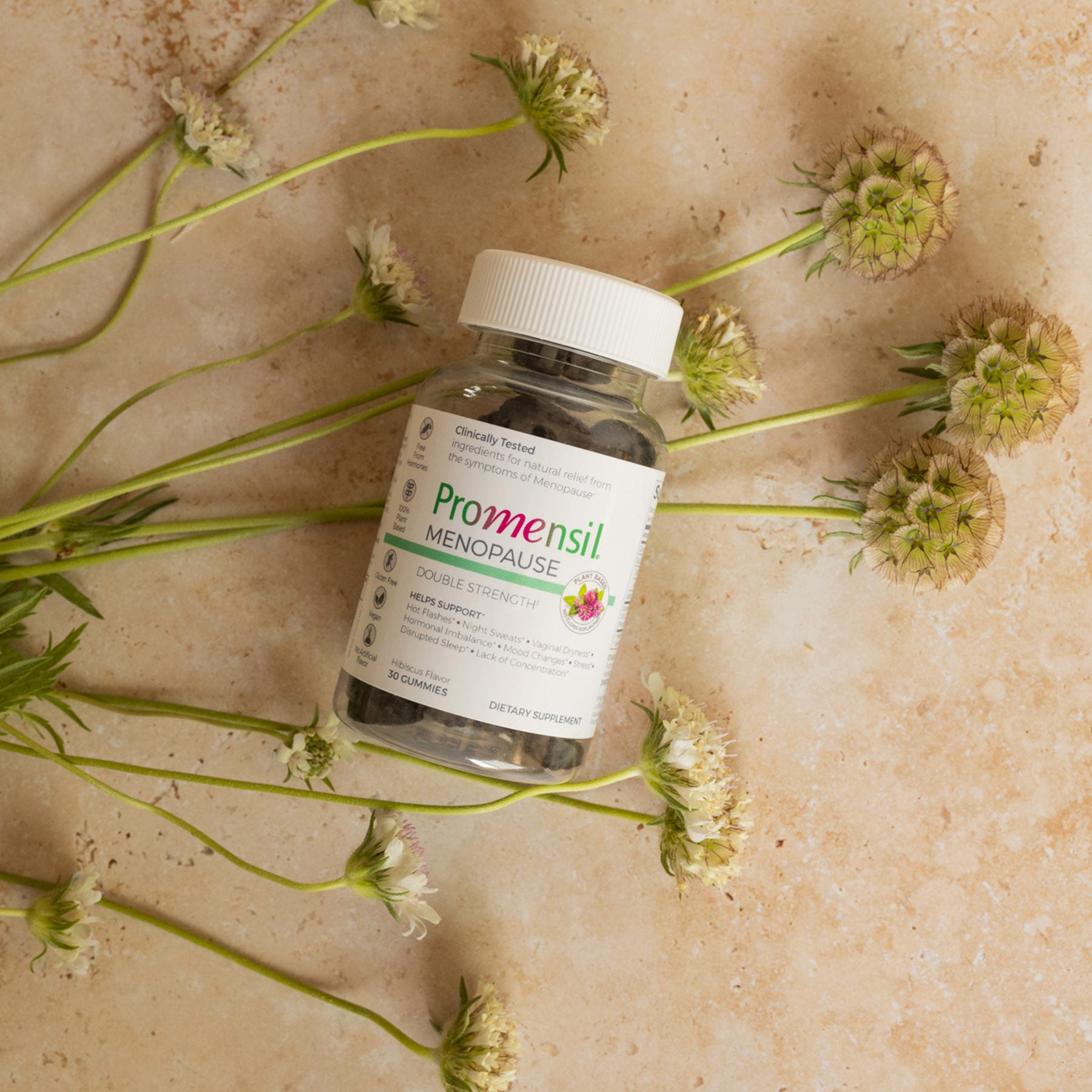 Promensil Menopause Double Strength Gummies bottle on flowers