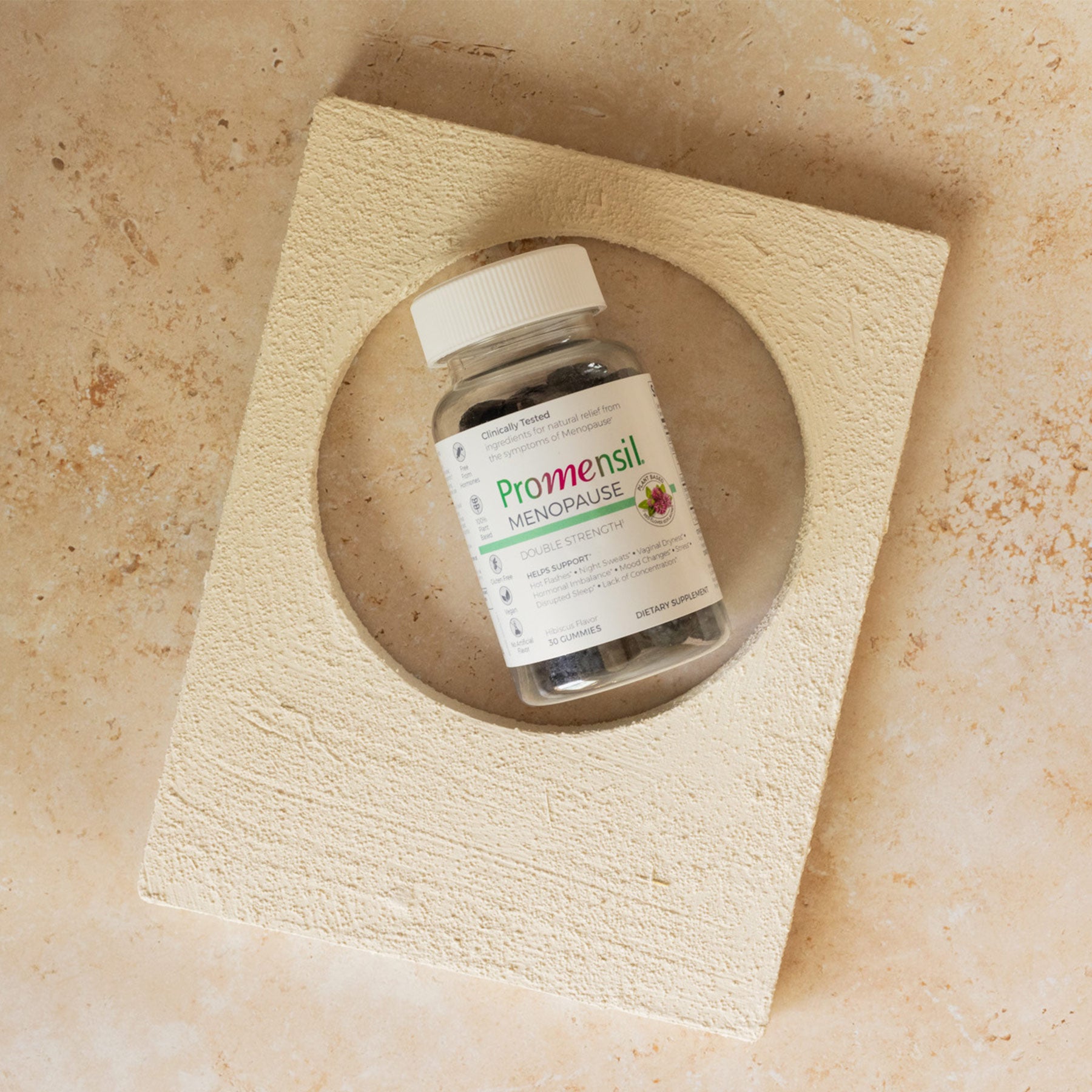 Promensil Menopause Double Strength Gummies bottle on a stone surface