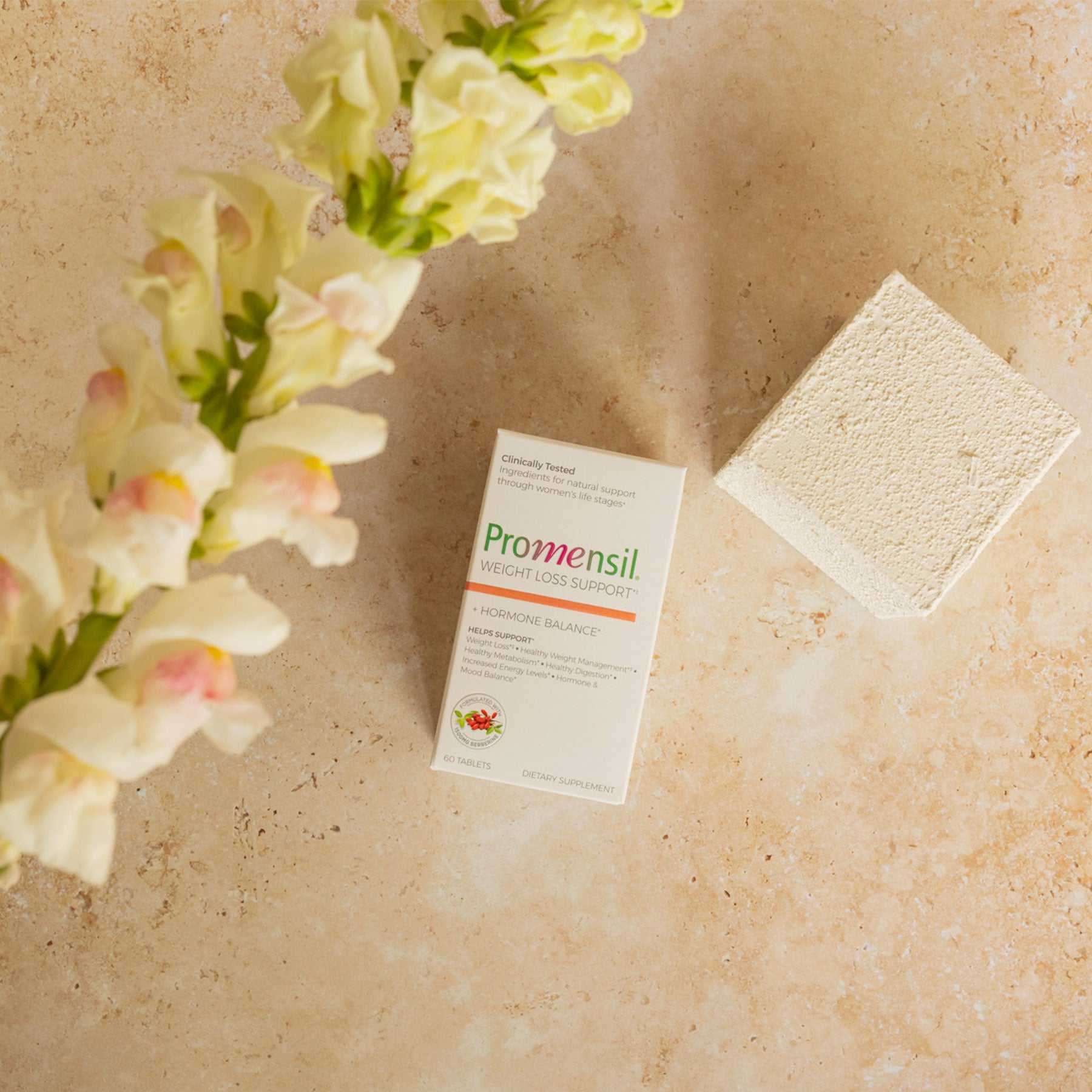 Promensil Weight Loss Support packaging  with flowers on a beige surface